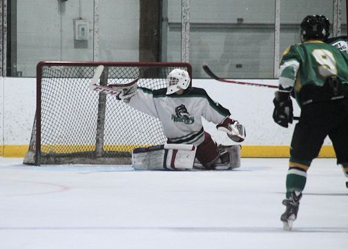 Wolves goalie Mitch Campbell deflects the puck into the corner off his blocker